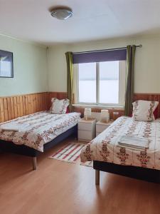 Postel nebo postele na pokoji v ubytování Arctic Colors Northern Lights Apartments
