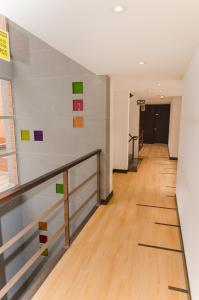 an empty hallway in an office building with colorful art on the walls at Scala 68 in Bogotá