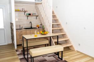 cocina con mesa y escalera en una habitación en apartman UNO, en Jajce