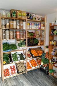 a refrigerator filled with lots of different types of vegetables at Espacio Finca Alegría - Rural Houses, Hostel, Campsite & Wellness Center in Cartagena