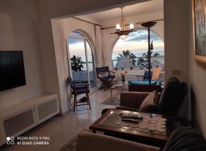 a living room with a view of the ocean at La Sabina in Mogán