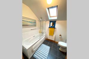 La salle de bains est pourvue d'une baignoire, de toilettes et d'un lavabo. dans l'établissement 3 Bedroom House located in Centre of Carndonagh, à Carndonagh