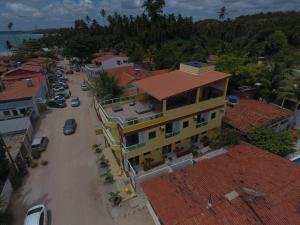 an aerial view of a town with a yellow building at Flats Parada Obrigatoria in Maragogi