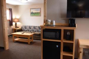 a living room with a couch and a table at Woodside Dells Hotel & Suites in Wisconsin Dells