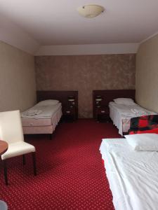 
Łóżko lub łóżka w pokoju w obiekcie Hotel TiM
