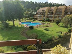 a view of a resort with a swimming pool at Departamento en el Centro de Pucón, Hermosa vista al lago !! in Pucón