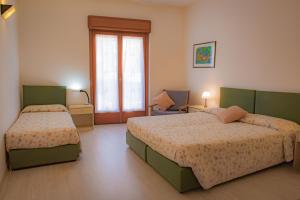 Postel nebo postele na pokoji v ubytování Hotel Zeni