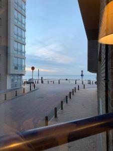 a view of a beach with a building and the ocean at De Branding in Blankenberge +7 photos