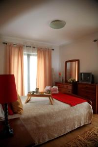 a bedroom with a large bed with a table on it at Casa Ana in Nazaré