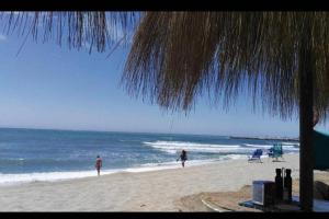 two people standing on a beach with the ocean at Ocean view, Luxury & Relax Dunas de Artola in Marbella