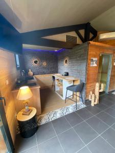 a small kitchen with a table and a desk at La Cabane d'Arès - chambre double PREMIUM in Arès