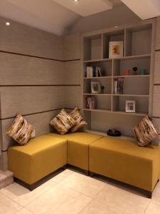 カシュにあるHotel Hermesの黄色のソファ(枕付)が備わる客室です。
