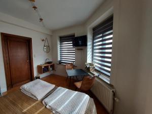 a bedroom with a bed and a desk and a window at Le cocon in La Roche-en-Ardenne