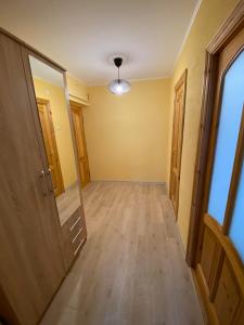 an empty room with a hallway with a door at Apes ielas apartaments in Alūksne