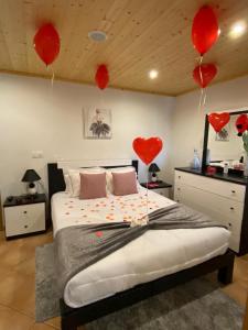 a bedroom with red hearts hanging from the ceiling at Alojamento Pelourinho in Melo