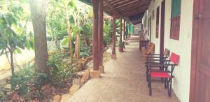 a walkway with chairs and tables on a building at Mi Ranchito, Centro in Barichara