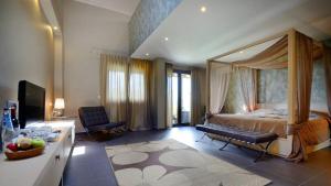 a bedroom with a canopy bed in a room at Atrium Hotel Thassos in Potos +37 photos