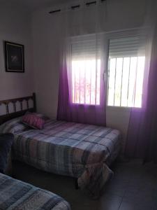a bedroom with two beds and a window at Casa al-andalus in Granada +27 photos