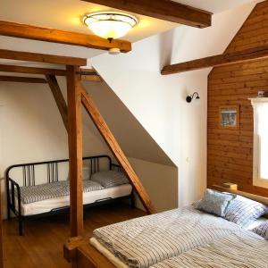 two beds in a room with an attic at Roubenka Volský Důl in Špindlerův Mlýn