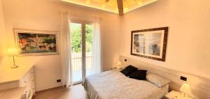 a bedroom with a bed and a large window at Affittacamere La Fonte in Levanto