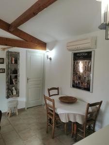 a dining room with a table and chairs at le petit st Jean in Cazouls-d Herault