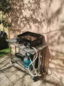 a stove on a cart on a patio at le petit st Jean in Cazouls-d Herault