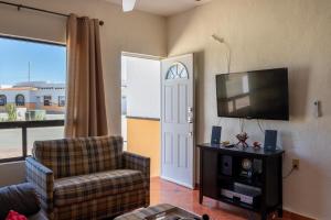 a living room with a tv and a couch and a chair at Mexican Ambience Townhome with Pool #2 in Puerto Peñasco