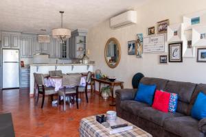 a living room with a couch and a kitchen at Mexican Ambience Townhome with Pool #2 in Puerto Peñasco
