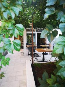 a patio with a table and some plants at Casa Segota in Veli Iž