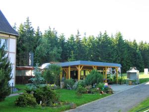 a house with a garden in front of it at Pension Harzbaude Susanne - Garni in Rübeland