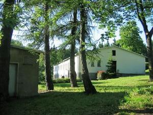 a white house with trees in front of it at Pension Harzbaude Susanne - Garni in Rübeland