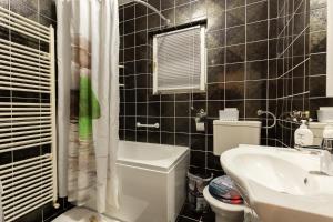 a bathroom with a white toilet and a sink at Apartman Vesna in Bjelovar