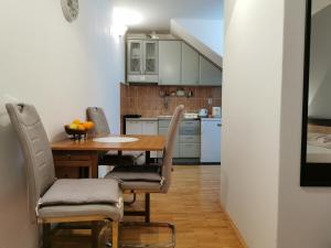 a kitchen with a table and chairs in a room at Apartment Vukasevic in Virpazar