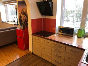 a room with a large wooden dresser with a television on top at Stamerienas Apartamenti in Stāmeriena