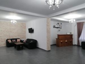 a living room with a couch and a table at Pensiunea Diana in Colibiţa