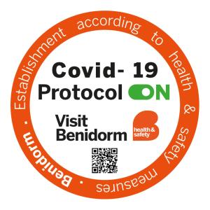 a label with the text covid protocol on it at Gemelos 22 - Fincas Arena in Benidorm