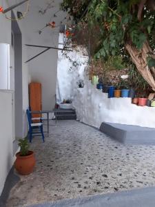 a room with a white wall with colorful pots at Despina garden view in Agia Galini