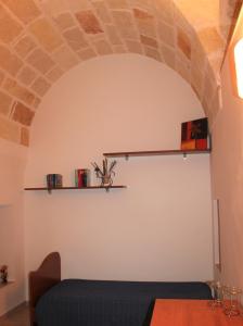 a living room with a blue couch and a brick wall at Dimora Nonna Sisina in Polignano a Mare