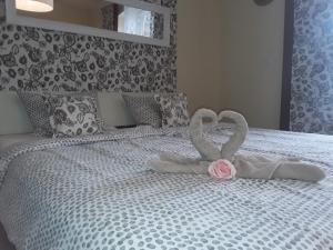 two swans made out of towels on a bed at Apartmany Villa Magnolie in Lipova Lazne