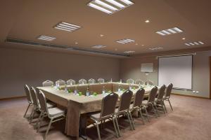 a conference room with a long table and chairs at Melia Madeira Mare in Funchal