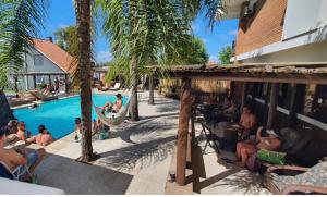 a group of people sitting around a swimming pool at Lira Apart Hotel in Cassino