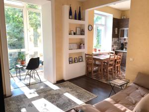 a living room with a couch and a dining room at Luxury Apartments in Odesa