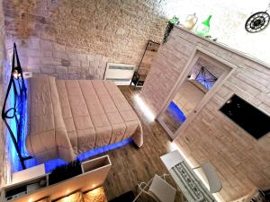 an overhead view of a bedroom with a bed and a brick wall at Trully in Alberobello