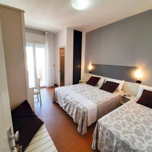 A bed or beds in a room at HOTEL CONTI