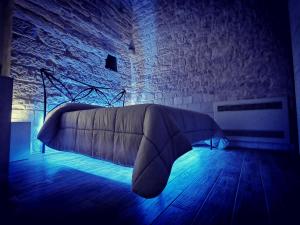 a bed in a room with a blue light at Trully in Alberobello