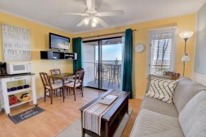 a living room with a couch and a table at Million Dollar Oceanfront View in Hilton Head Island