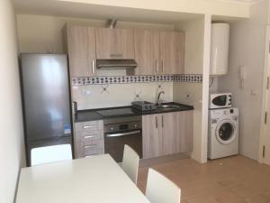 a small kitchen with a sink and a refrigerator at Residencial Alhambras1 in Murcia