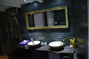 a bathroom with two sinks and a mirror at B&B Torre Porta Marina in Ventimiglia