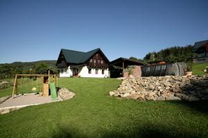 a yard with a playground and a house at Apartmány Fišerka in Rokytnice nad Jizerou