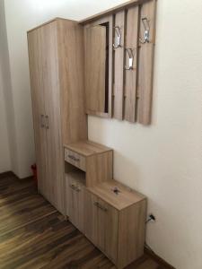 a wooden cabinet in a room with wooden floors at Apartment Sara in Mostar